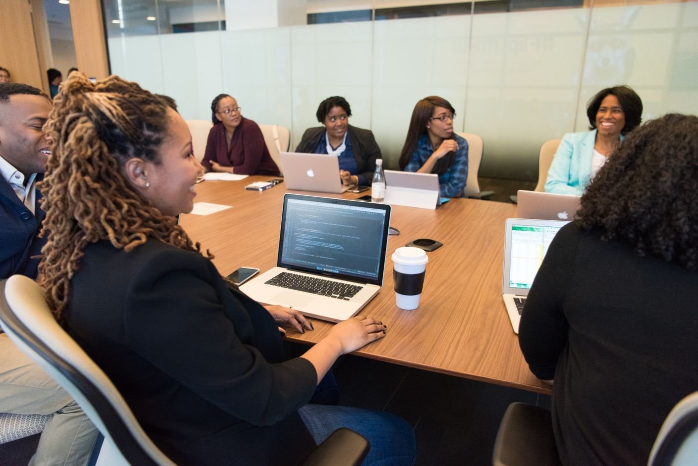 The Infinite Solutions team collaborating around laptops in a meeting